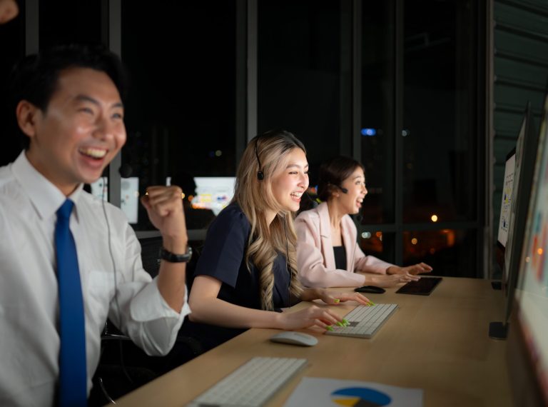 Successful asian business people celebrating success in office at night, International financial investment company concept