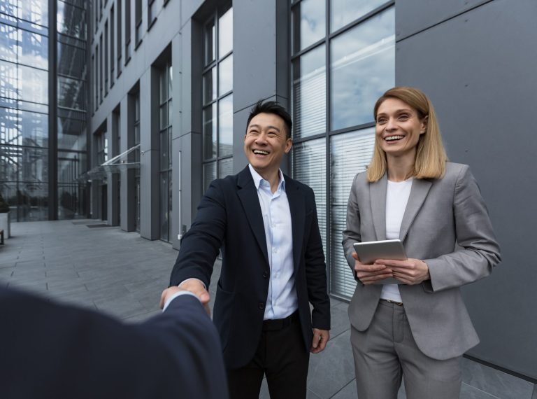 Three experienced managers team leaders, meet and get to know from outside the office team, diverse group of entrepreneurs shake hands men, introduce new colleague